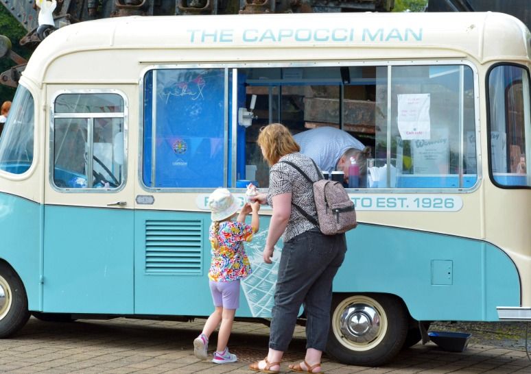 A woman and child getting ice cream from the Capocci Man Ice Cream van at Summerlee Museum